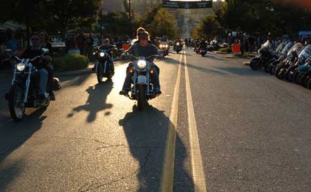 Bikers ride up and down Dickson Street on Friday evening in Fayetteville during the annual biker fest Bikes, Blues & BBQ. Around 400,000 people were expected to attend this year's rally. 