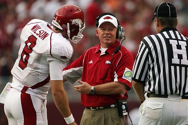 Arkansas Coach Bobby Petrino talks with linesman Johnny Crawford about one of the 11 penalties assessed against the Razorbacks in Alabama's 35-7 victory Saturday. Arkansas and Texas A&M are two of the most heavily penalized teams in the nation.