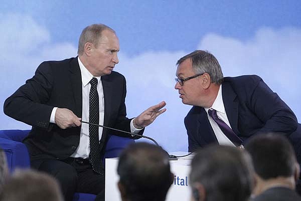 Vladimir Putin, Russia's prime minister, speaks with Andrei Kostin, chief executive officer of VTB Bank, during the Russia Calling VTB investment forum in Moscow on Tuesday.