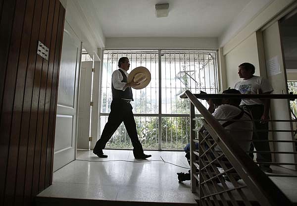 Honduras' ousted President Manuel Zelaya walks inside the Brazilian Embassy on Tuesday in Tegucigalpa.