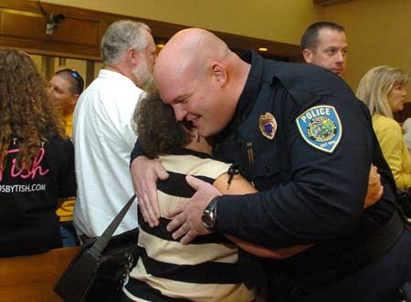 Sgt. Creston Mackey, with the Fayetteville Police Department, gets a hug from his mother-in-law, Janet Delany, Tuesday after a promotion ceremony held by the police department in City Hall. Mackey is one of four officers promoted to sergeant during the ceremony. 

