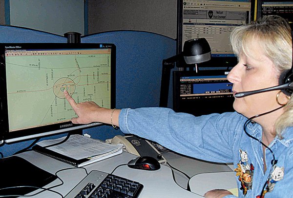 Dispatcher Luan Rogers points to a locator map pinpointing the area from which a cellphone caller dialed 911 in Pine Bluff in this October 2009 file photo.