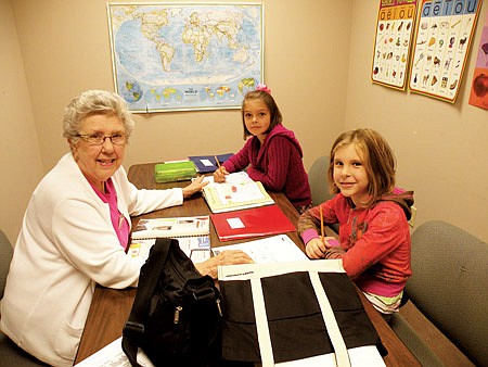 Shirley Harvey, left, has tutored in Jessieville School District for 15 years. She is shown here helping Jessieville Middle School students Bailee White, front right, a seventh grader, and Hayley Butterbred, back, an eighth grader. Harvey helps these students with reading and comprehension.