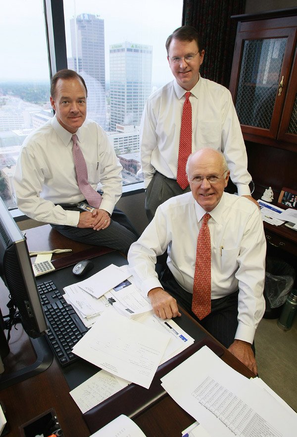 Brian Bush (left), Alan Tedford (standing) and Bill Tedford, all vice presidents with Stephens Capital Management, say the Federal Reserve’s increase in the monetary base will spur inflation.
