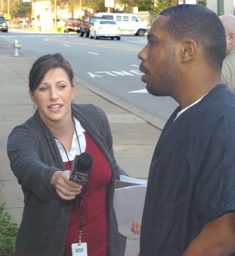 Jill Monier, a reporter with Fox 13 News WHBQ-TV asking Curtis Vance a question Wednesday as he is led into the Pulaski County Courthouse.