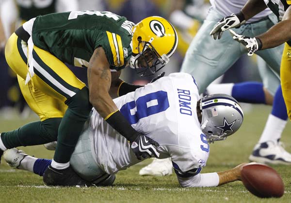 Charles Woodson of the Green Bay Packers hits Tony Romo of the Dallas  Cowboys forcing a fumble at Lambeau Field on November 15 …