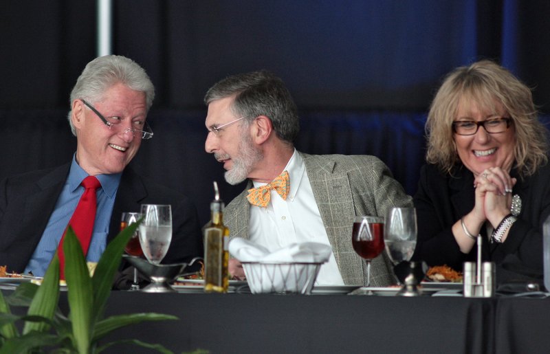 Former President Bill Clinton jokes with Little Rock city director Dean Kumpuris and Clinton Presidential Library director Terri Garner before giving a keynote address to supporters of the Clinton Presidential Center at a ceremony commemorating its 5th anniversary Wednesday in Little Rock.