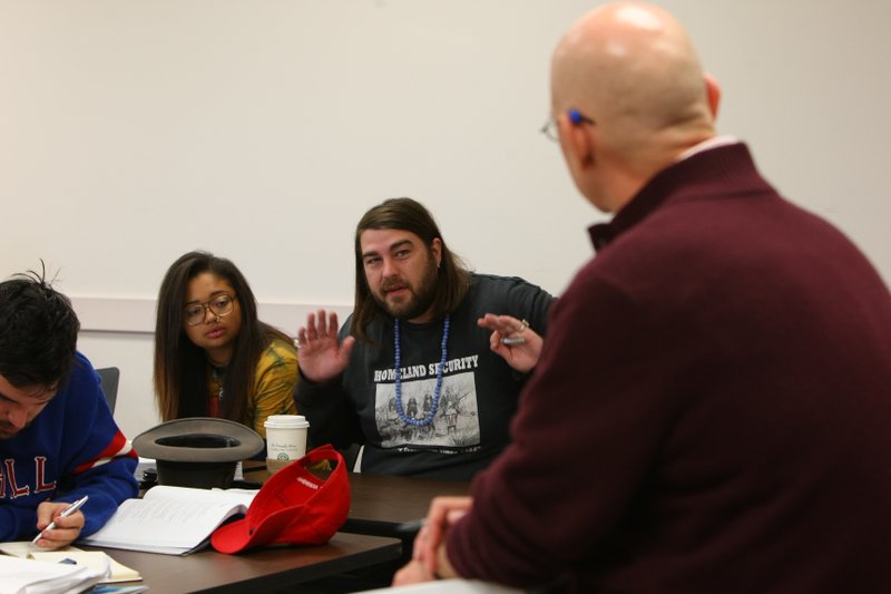 Student Holland Colclasure, left, talks with Dr. Paul Yoder, right, during their class on Bob Dylan at UALR Tuesday afternoon.