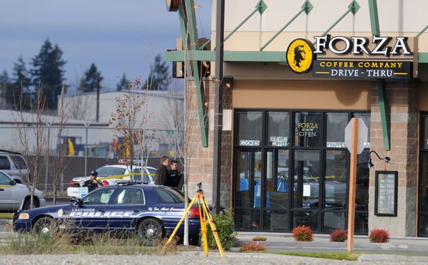 Police gather at the site where four police officers were killed in an ambush at the Forza Coffee Co. near Parkland, Wash., Sunday.