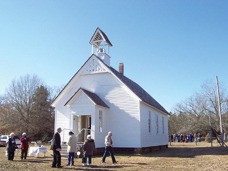 A group of people walk around the outside of the Smyrna Church in Searcy during a Walk Through History program sponsored by The Arkansas Historic Preservation Program in cooperation with the White County Historical Society and the Searcy Arts Council. Built in 1856-57, Smyrna Church is the oldest “documented” church building in Arkansas.