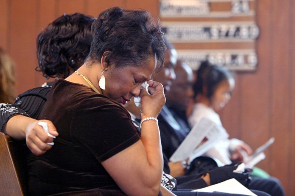 Jackie Brown wipes a tear Saturday as she is joined by 100 mourners at a memorial service in Little Rock for her daughter, Carmeletta Green, who had been missing since 1982. Carmeletta’s skeletal remains were not identified until Nov. 30 this year.