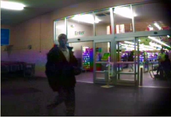 A photo taken from a security camera shows an unidentified man at the entrance of the Sherwood Wal-Mart. The man is accused of running off with the Salvation Army bucket.