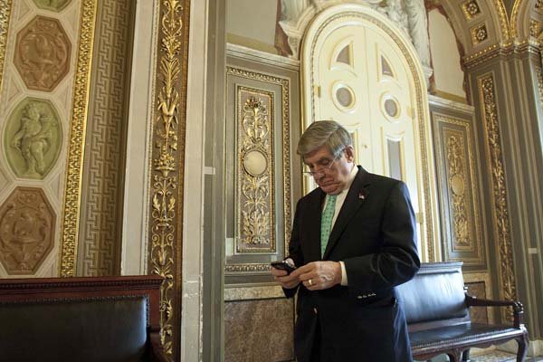 Sen. Ben Nelson, D-Neb., checks his BlackBerry in the Senate Reception Room on Saturday after deciding to support the healthcare overhaul bill. 