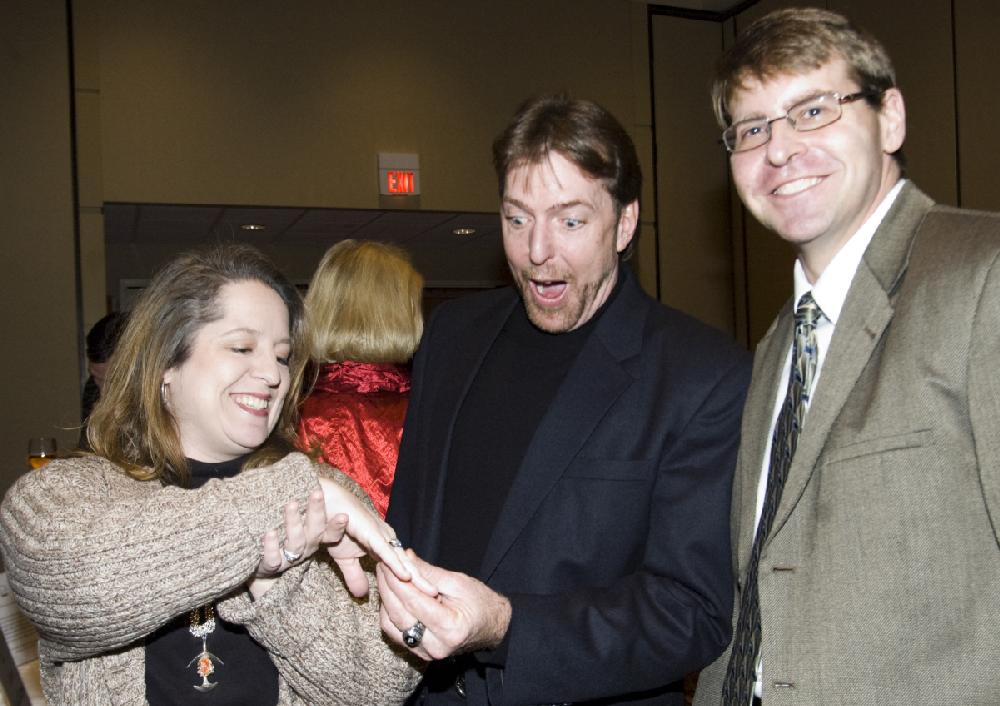 Arkansas Democrat-Gazette photo by Cary Jenkins 120909Diana Varady shows Jay Atkins and her husband Steve, the diamond ring that was being auctioned