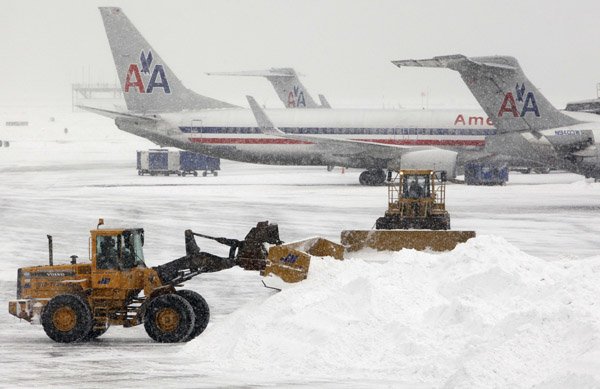 Crews work to clear snow from the tarmac at Logan International Airport in Boston.