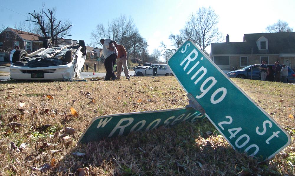 Arkansas Democrat-GazetteSTEVE KEESEE 122109 An upside down Toyota sits in a vacant lot after knocking down a street sign at the intersection of Roosevelt Road and Ringo St., Little Rock, Monday after it was struck broadside by an older model Mercury just before 1 p.m.. A man from the Toyota was taken by ambulance to area hospital with what appeared to be non-life treating injuries.