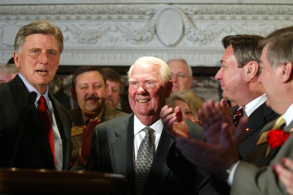 Arkansas Democrat-GazetteRICK MCFARLAND--21507-- Former state Sen. Bud Canada (center) is acknowleded by Gov. Mike Beebe (left) before he signed into law the bill calling for a 50 percent sales tax cut on groceries at the state Capitol Thursday. Canada tried several times during past Legislative sessions to get bills passed to reduce or eliminate taxes on food. Rep. David Evans, D-Searcy (second from right), and Speaker of the House Rep. Benny Petrus, D-Stuttgart (far right) were clapping for him.