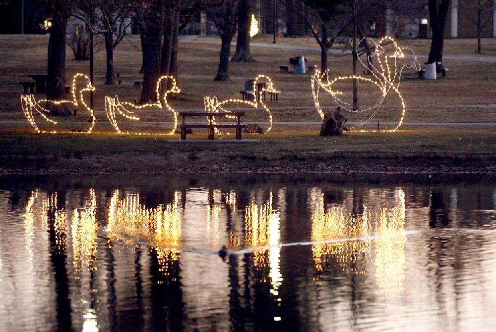 Arkansas Democrat-GazetteJASON IVESTER 12-15-09Lit swans are reflected in the water Tuesday, Dec. 15, 2009 at Murphy Park in Springdale.