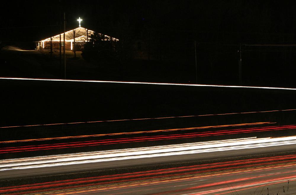Arkansas Democrat-GazetteDAVID GOTTSCHALK
Traffic on I-540 passes by an illuminated Western Hills Baptist Church on South Shiloh Drive in south Fayetteville Tuesday night.
121509