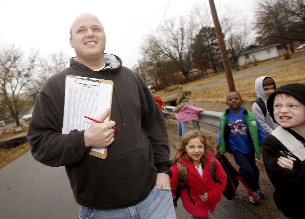 Arkansas Democrat-GazetteJASON IVESTER 12-08-09Zach Dean, executive director for the Boys & Girls Club of the Alma Area shot on Tuesday, Dec. 8, 2009 inside and outside the centerZach Dean, executive director for the Boys & Girls Club of the Alma Area, walks children from their buses to the center on Tuesday, Dec. 8.