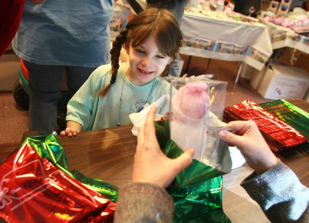 Arkansas Democrat-GazetteRICK MCFARLAND--122109-- Nevaeh Landeros (cq), 5, of Berryville, watches as a gift she picked out for a her mom is wrapped along with ones' for her dad, 2 brothers and 2 sisters at Arkansas Children's Hospital in Little Rock Monday. Landeros is a patient there and they are given the opportunity to shop items for free to give their familes for Christmas. This is the 9th year that the Kids Korner Gift Shoppes has donated gifts for the program.
