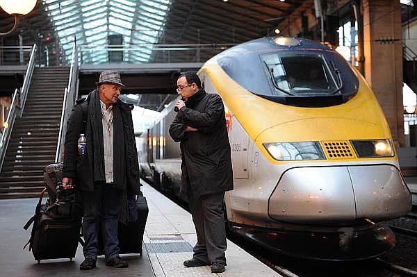 A Eurostar employee (right) assists a passenger at Gare du Nord train station in Paris, France, on Monday.