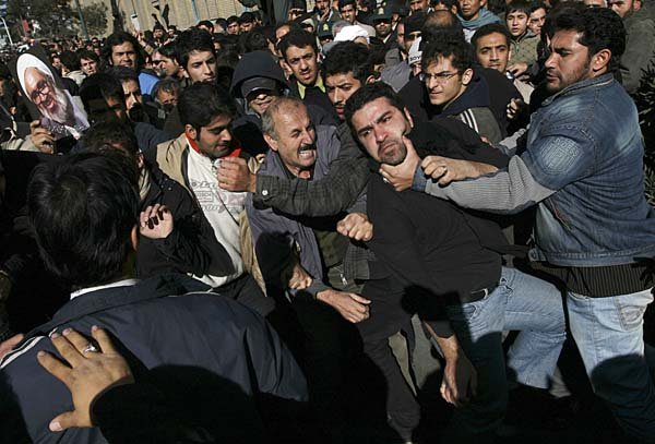Opposition supporters and pro-government demonstrators scuffle at the funeral ceremony for Grand Ayatollah Hossein Ali Montazeri on Monday in Qom, Iran.