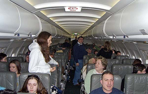 Stranded passengers aboard a JetBlue Airways flight to Cancun walk around the cabin while waiting hours to take off at New York’s Kennedy International Airport on Feb. 14, 2007.