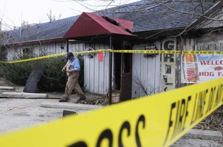 Dennis Ledbetter, fire investigator with the Fayetteville Fire Department, walks out of the Restaurant On The Corner at 3582 Arkansas 112 in Fayetteville on Tuesday. An early morning fire left the restaurant closed and quarantined. The cause of the fire is under investigation, said Battalion Chief Terry Lawson.