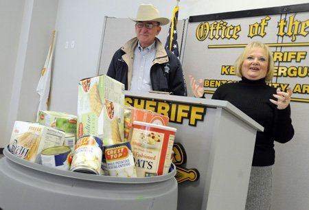 Marge Wolf, right, director of the Northwest Arkansas Food Bank, thanks the Benton County Sheriff’s Office and partner agencies Wednesday in Bentonville following Sheriff Keith Ferguson’s announcement of an 8,371-pounds-of-goods donation to the Northwest Arkansas Food Bank. The donation surpassed the Sheriff’s Office’s 2008 donation by 3,656 pounds.

