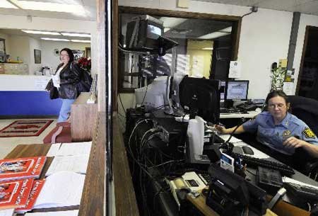 Angie Cope, right, telecommunication supervisor, sits at the dispatch station in the state police headquarters on Monday in Springdale.