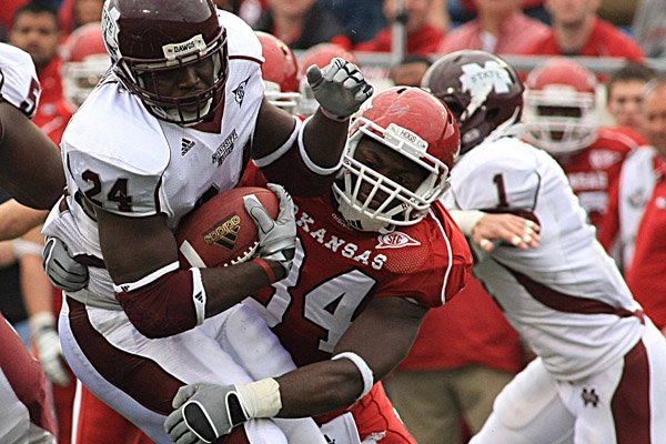  Arkansas defender Jerry Franklin brings down Miss. State running back Anthony Dixon during the first quarter  at War Memorial Stadium in Little Rock.