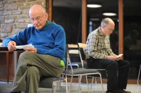 Quakers Peter Marchant, left, and David Schoen ponder the definition of a series of “spiritual gifts” during an exercise conducted by Marianne Lockhard for the Fayetteville Friends Meeting (Quakers) on Dec. 20.