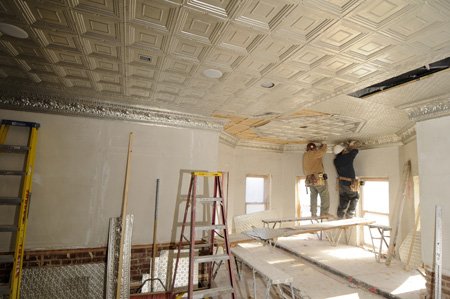 Workers finish installing a metal ceiling Dec. 10 in the balcony of the historic Washington County Courthouse in Fayetetville.