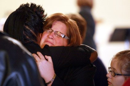 Cindy Wise, wife of Salvation Army Maj. Philip Wise, is comforted by a woman attending the Sunday church service at the Salvation Army Corps Community Center in North Little Rock. Philip Wise, 40, was shot and killed at the center Christmas Eve.