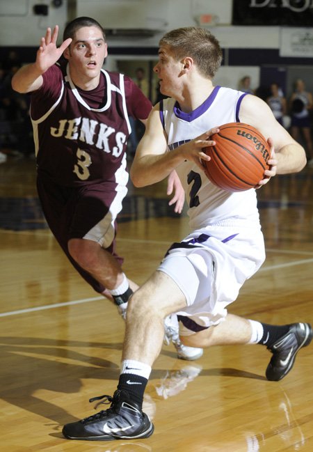 Fayetteville’s Jack Jones, right, looks to pass the ball as Jenks’ Mason Evans defends in the first half Dec. 1 in Fayetteville.
