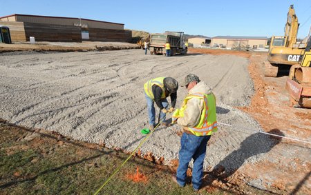 Washington County workers construct the pad for a planned training facility for the Washington County Sheriff’s Office on Dec. 17, north of the Washington County Detention Center in Fayetteville.