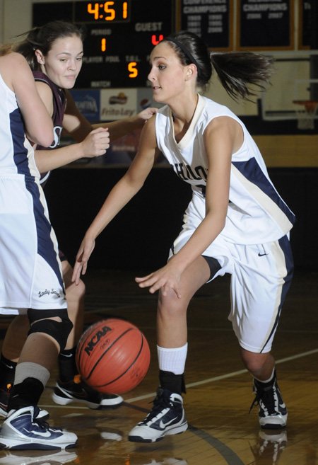 Shiloh Christian’s Meagan Henley, right, dribbles during Monday’s game against Siloam Springs in Springdale.
