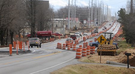 Traffic moves Wednesday along Arkansas 102 in the construction area between Bentonville and Centerton.