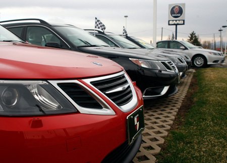 A row of 2008 sedans sits at a Saab dealership in Boulder, Colo. General Motors Co. said Wednesday that it will continue to hear bids as it begins to shut down operations.