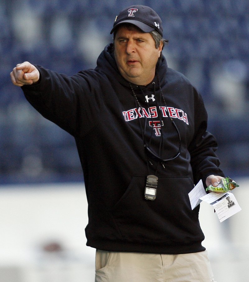n this Dec. 28, 2008, file photo, Texas Tech head coach Mike Leach gives directions to his team during football practice for the Cotton Bowl NCAA college football game at Texas Stadium in Irving, Texas. 
