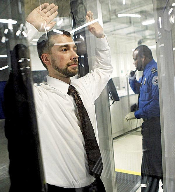  Tanner Suttles, left, a Transportation Security Administration employee is screened by a TSA officer during a demonstration of passenger screening technology, Wednesday, Dec. 30, 2009, at the TSA Systems Integration Facility in Arlington, Va. 