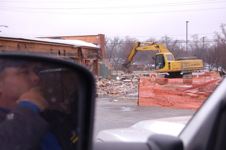 Capt. Tony Grimes watches as Bentonville’s old Fire Station No. 1, at 215 S.W. “A” St., is demolished Wednesday. The city plans to build an activity center on the property to open in March 2011.