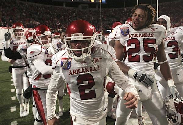 Arkansas kicker Alex Tejada is surrounded by teammates after kicking a game winning field goal in overtime to beat East Carolina 20-17 in the Liberty Bowl.