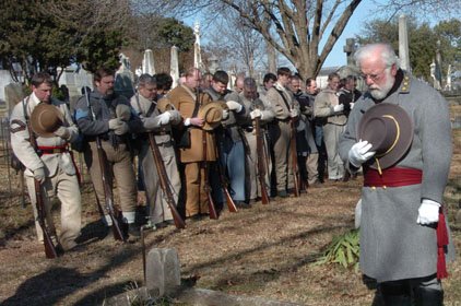 W. Danny Honnoll (right) leads a prayer Saturday at the grave of David O. Dodd, who was executed by Union troops for being a Confederate spy.