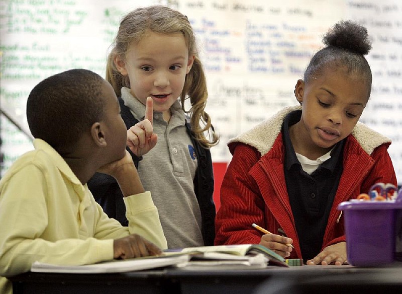 Arkansas Democrat-GazetteBENJAMIN KRAIN --11410--Second-graders Kandall Marshall, left, Lauren Esten and Jayda Butler participate in class at e-STEM Public Charter School Thursday morning. Roy Brooks, the CEO of e-STEM announced Thursday that he will be resigning at the end of the school year.