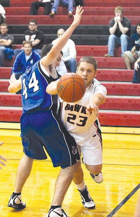 Rea Ridge Blackhawk forward Cameron Thompson, No. 23, passed under Rogers Mounties post Nathan Musso, No. 44, in a home game in November.