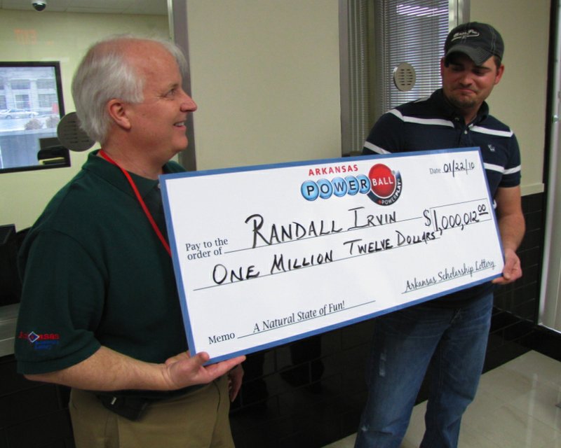 Uniontown resident Randall Irvin and Arkansas Scholarship Lottery Vice President of Gaming David Barden pose with an oversized check Friday marking Irvin's $1 million Powerball win. 