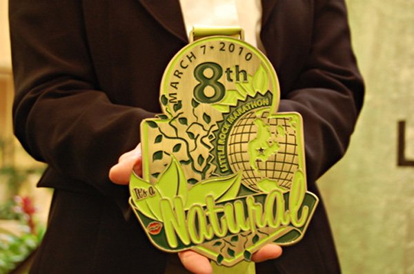 The 2010 Little Rock Marathon medal is unveiled.