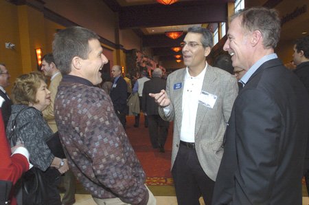 TALKING BUSINESS - Jay Lewis, from left, Craig Rivaldo and Don Schapp visit Friday before the business forecast lunch at the John Q. Hammons Center in Rogers.
